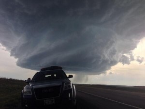The chase vehicle sitting in front of a very photogenic supercell.